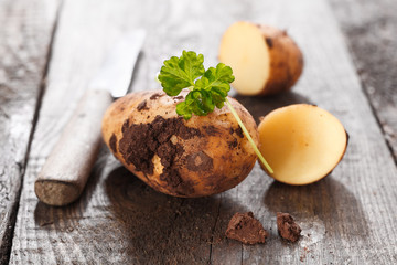 Halved and whole fresh potato