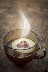 A Cup of Black Tea with One Piece of Apple Cutting in the Shape