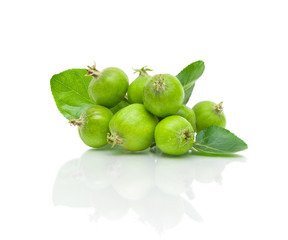 green apples and leaves on a white background
