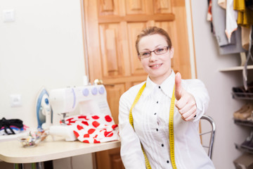 smiling dressmaker in a workroom