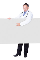 Portrait Of A Doctor Holding Blank Placard