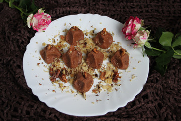 Homemade truffles with walnut in white plate