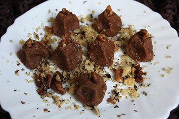 Homemade truffles with walnut in white plate