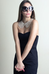 Elegant young woman in sunglasses.