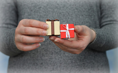 two gift boxes in woman's hands, close-up