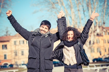Happy Young Couple with Outstretched Arms