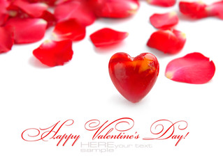 Valentines Day background. Red heart on a background pink petals