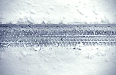 Deurstickers Detail of car’s tire track in snow © ngaga35