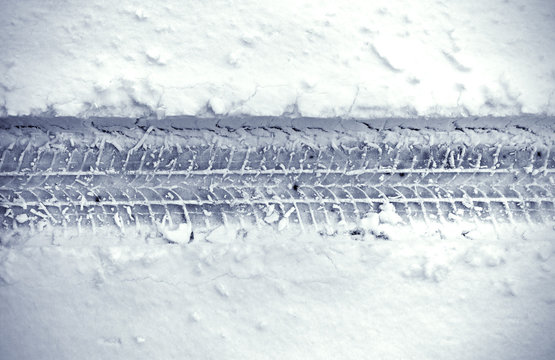 Detail of car’s tire track in snow