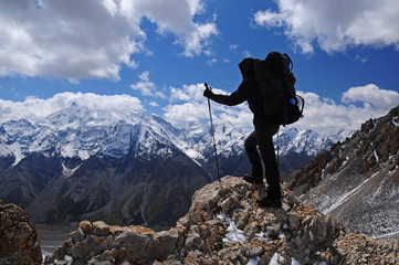 Young woman enjoys spectacular view to high mountains