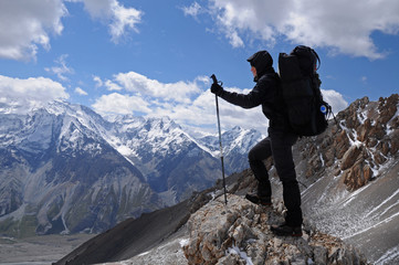 Young woman enjoys spectacular view to high mountains