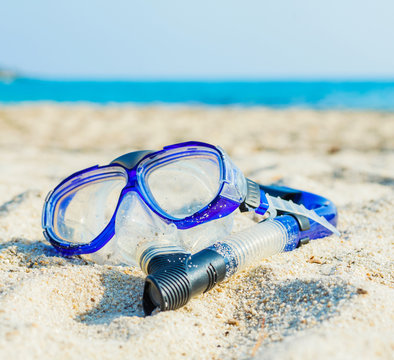 snorkel and mask on the beach.
