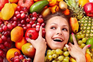 Girl in group of fruit.