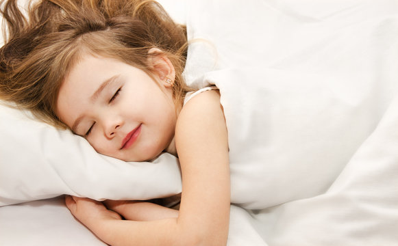 Little girl sleep in the bed close-up