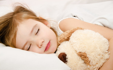 Adorable little girl sleeping in the bed