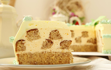 Piece of beige creamy cake with nuts