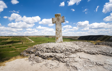 Stone cross under blue sky