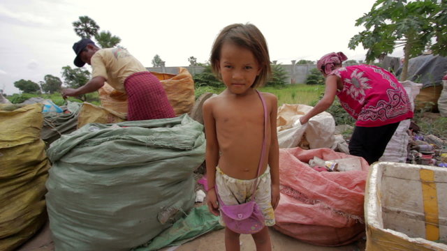 Garbage gatherers assorting trashes in slums