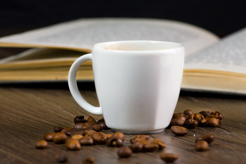 black strong coffee on the table and reading book