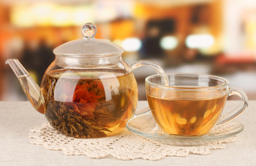 Exotic green tea with flowers in glass teapot