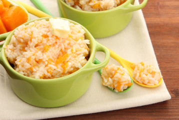 Taste rice porridge with pumpkin in saucepans