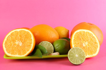 Fruits with leafs on pink background