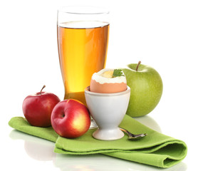 Light breakfast with boiled egg and glass of juice, isolated