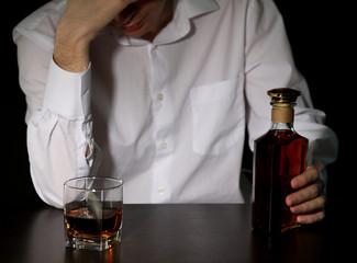 Man with bottle of alcohol,  on black background