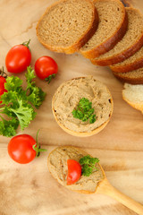 Fresh pate on wooden spoon, on wooden background