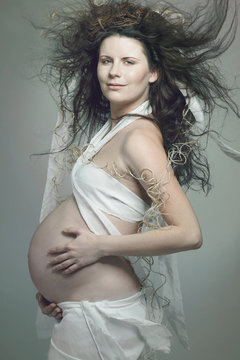 Pregnant woman with long curly hair.