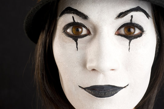 Female in White Face Playing a Clown or Mime
