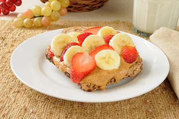 Peanut butter sandwich with banana and strawberries