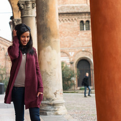 Fototapeta na wymiar Young woman walking outdoors in s. Stephen, Bologna, Italy.