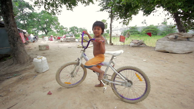 cambodian kids in slums near phnom penh city dumping area