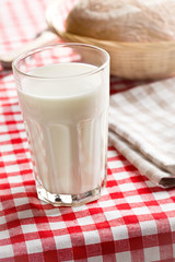 glass of milk on checkered tablecloth