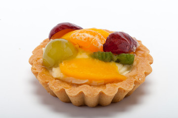 sweet cake with fruits isolated on white