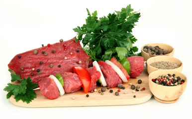 Raw beef meat marinated with herbs and spices isolated on white