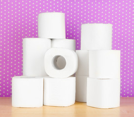 Rolls of toilet paper on purple with dots background