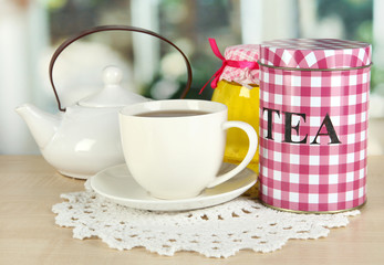 Jar and cup of tea isolated on white