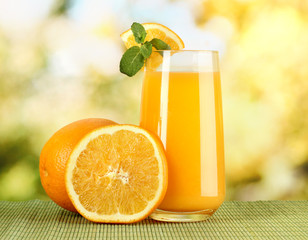 Glass of orange juice with mint and orange