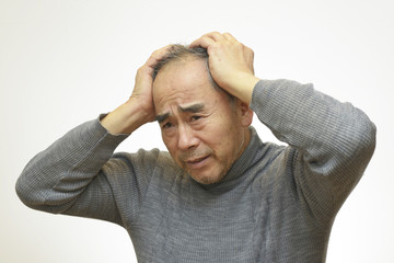 頭を抱えている男性