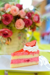 Strawberry cake with flowers on table