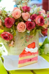 Obraz na płótnie Canvas Strawberry cake with flowers on table