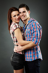 Closeup of cheerful young couple embracing