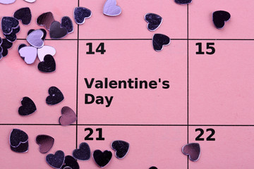 Notes on the calendar (valentines day) and rose, close-up