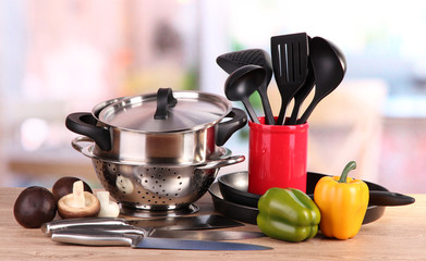 composition of kitchen tools and vegetables on table in kitchen