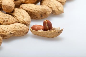 .Dried peanuts in closeup on the white background