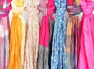 Many bright female scarfs isolated on white