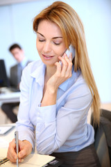 Smiling businesswoman talking on mobilephone