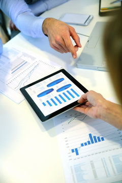 Closeup of tablet screen presenting charts